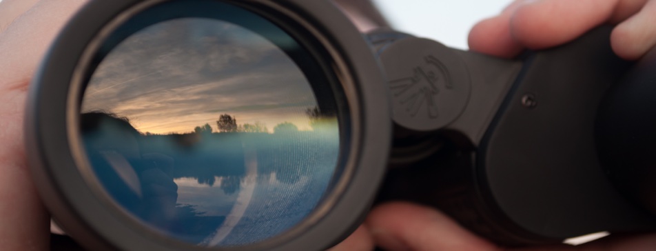 Reflection of the sky in a binocular lens.