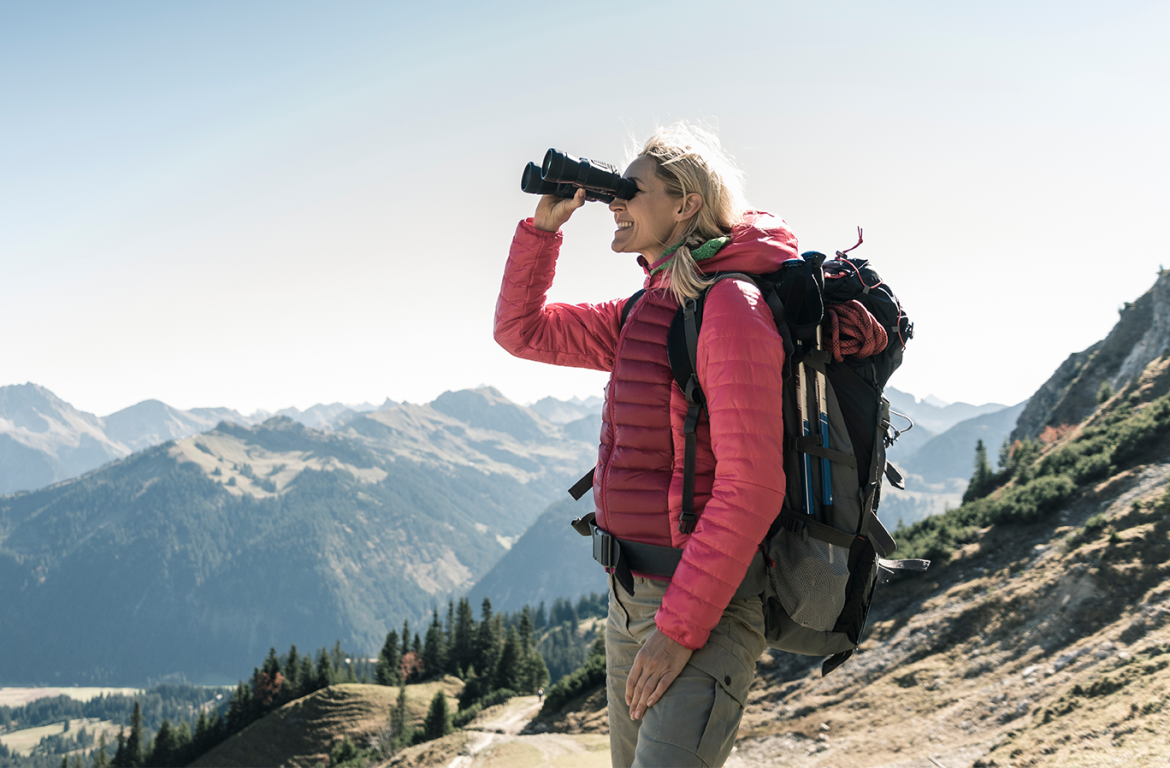 Women looking out at mountain with binoculars